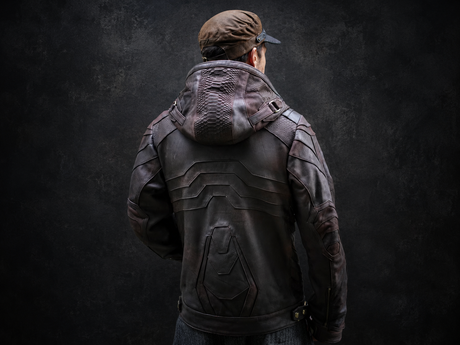 Brown hooded leather jacket back view with armored panels, structured hood, and dark studio background.