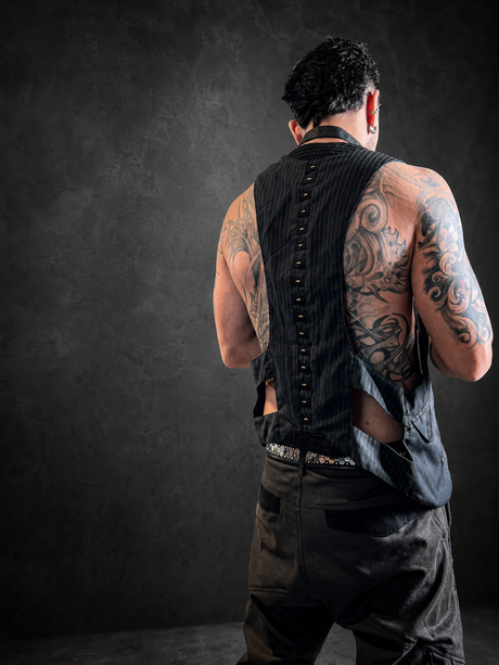 Back view of The Charmer Waistcoat handmade in Bali from Italian wool with open leather sides and decorative rivet spine.