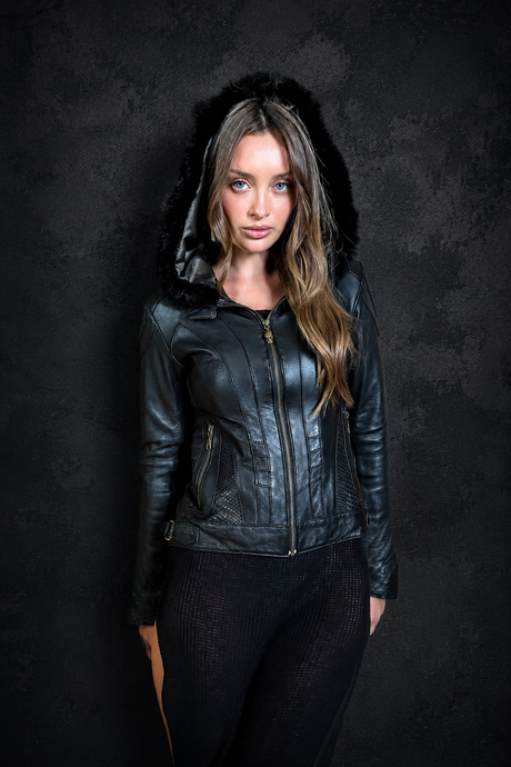 The Night Huntress Hooded Leather Jacket worn from the front, showing black fitted leather body, structured hood, front zipper, deep pockets, and dark studio background.