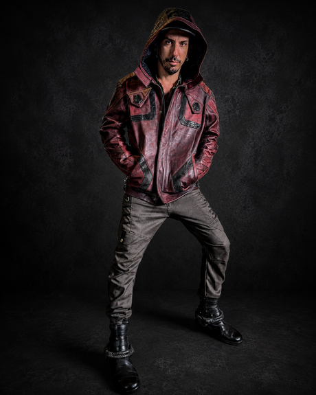 The Oxblood Sentinel Hooded Jacket worn in a full front studio shot, showing deep oxblood leather, structured hood, front pockets, black panel details, and dark Rebel Armada styling.