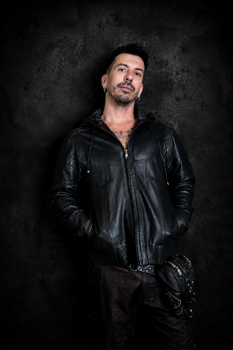 The Shadow Switch Leather Hoodie Jacket worn open from the front, showing black leather texture, hooded neckline, front zipper, and deep pocket placement.
